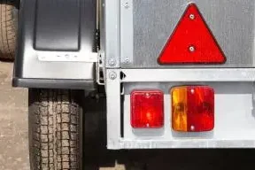 Technician repairing trailer lighting electrics