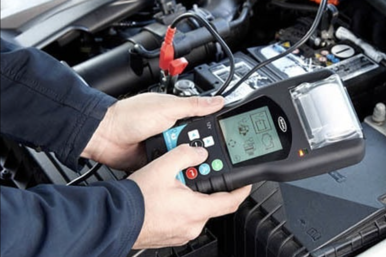 Technician testing a battery and charging system in Coleford