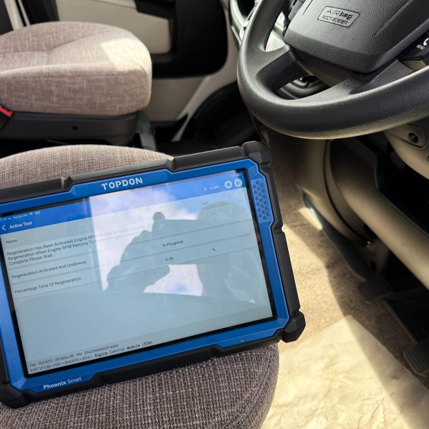 Mobile technician using diagnostic machine in the forest of dean